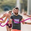 Homme avec dossard de course, tape dans la main d'une femme
