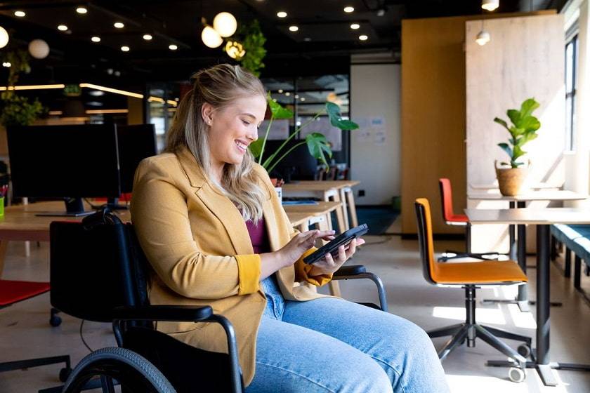 Femme souriante sur un fauteuil roulant 