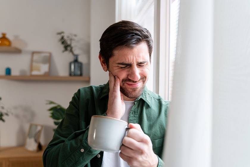 Un homme se tenant la joue avec sa main